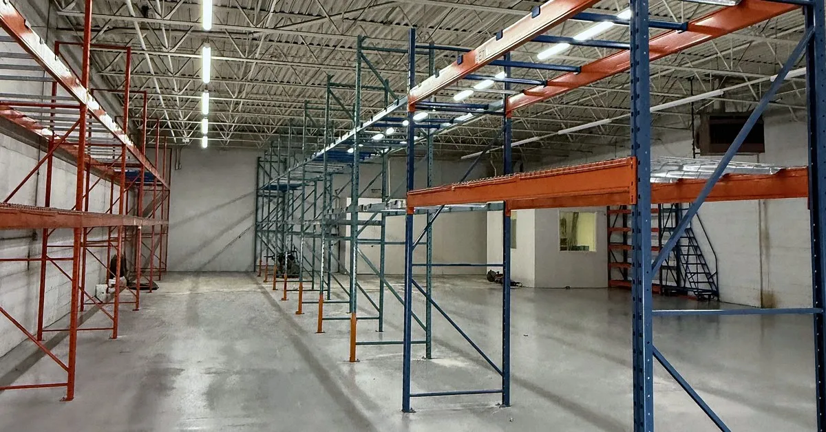 Pallet racking frames and beams going up in an empty warehouse