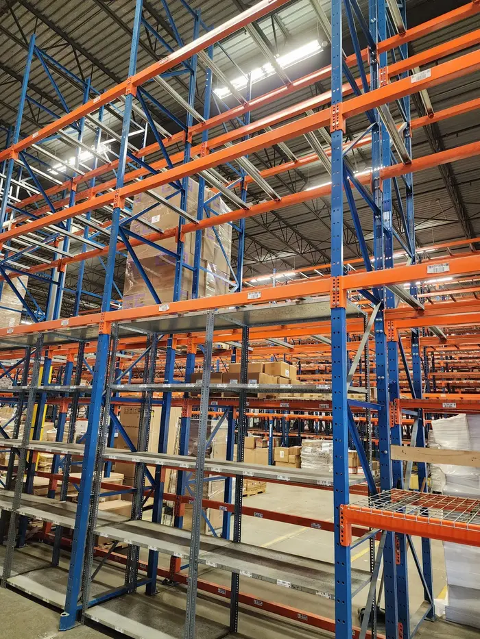 Tall blue and orange racking seen from the aisle