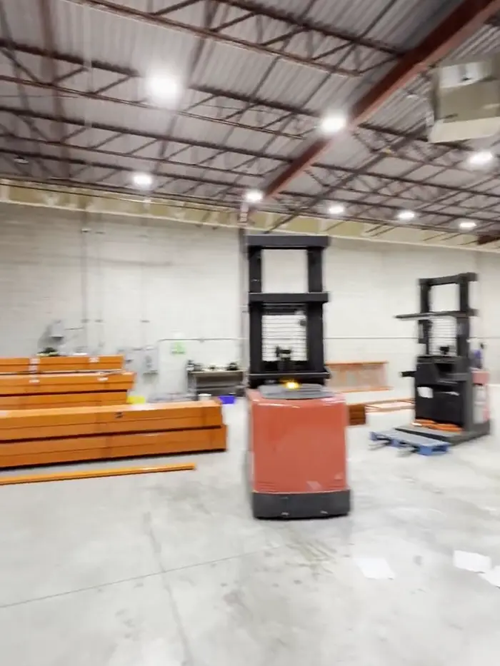 Frames down and beams stacked beside two order pickers