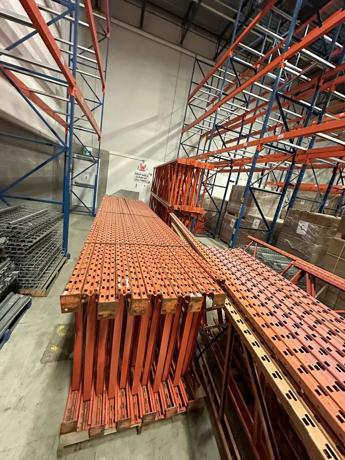 Orange frames and beams laid down in a seller's warehouse