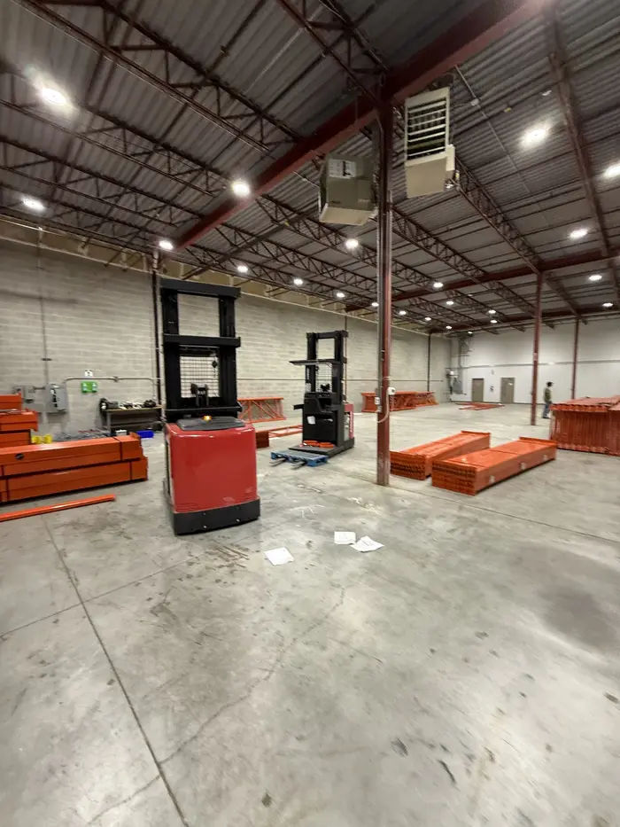 Beams and frames stacked on a warehouse floor