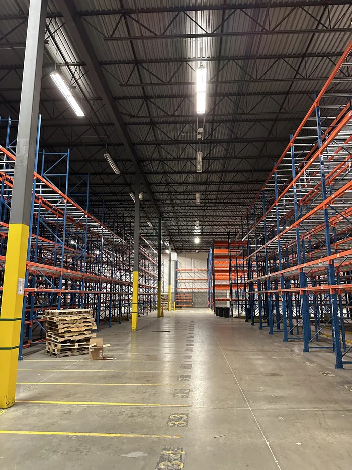 A long racked aisle in a large warehouse