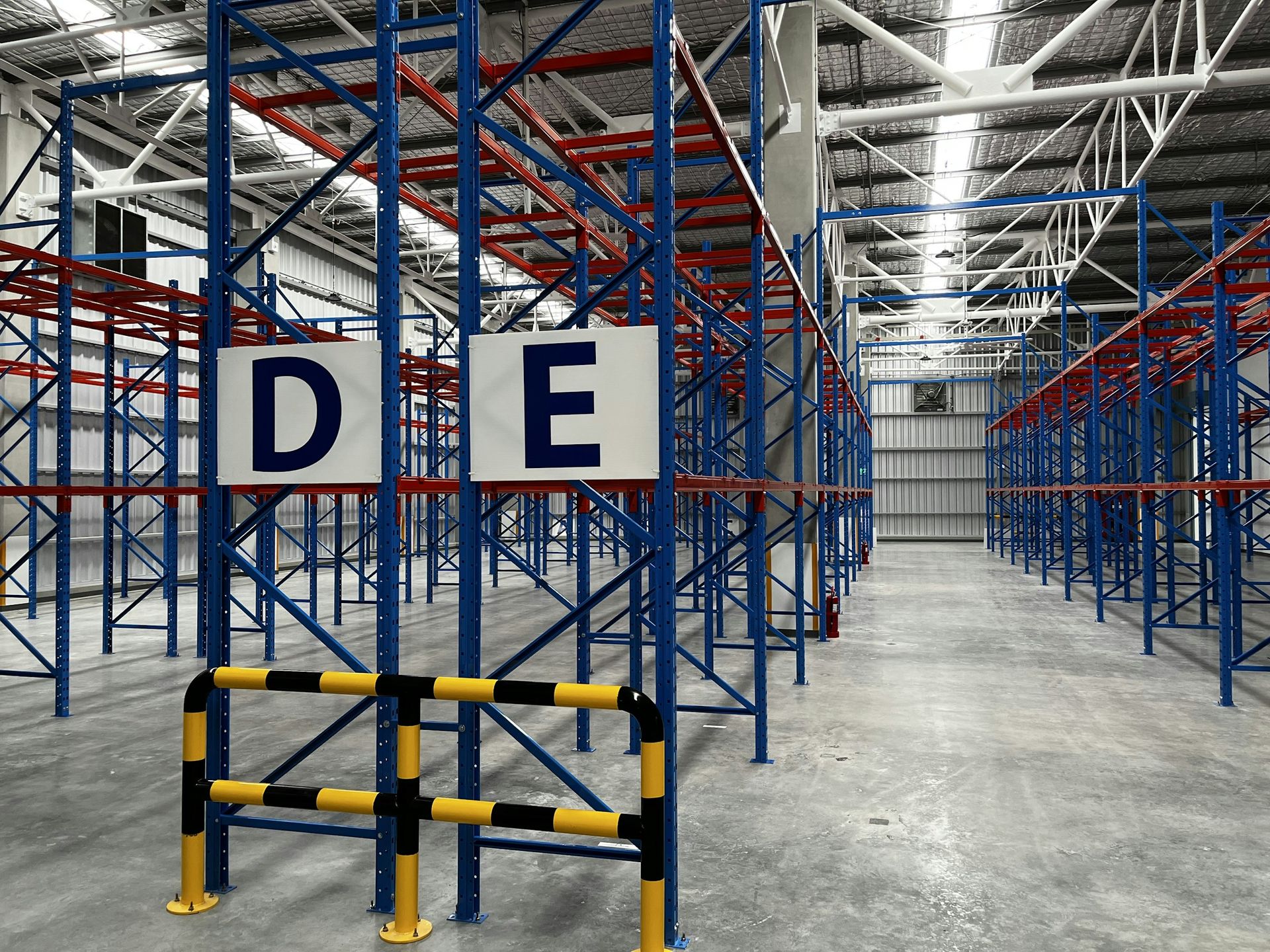 Emptied pallet racking bays with guard rails