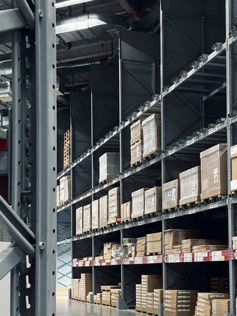 Dark steel pallet racking with clearance signage