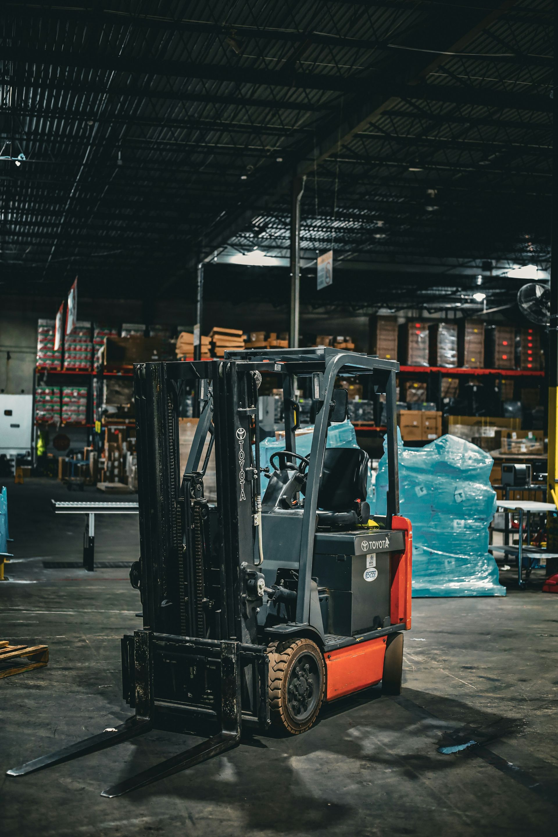 Forklift in a dark industrial warehouse