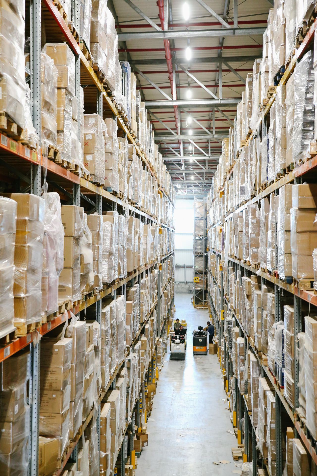 Tall, fully loaded narrow-aisle pallet racking in a high-density warehouse (illustrative)